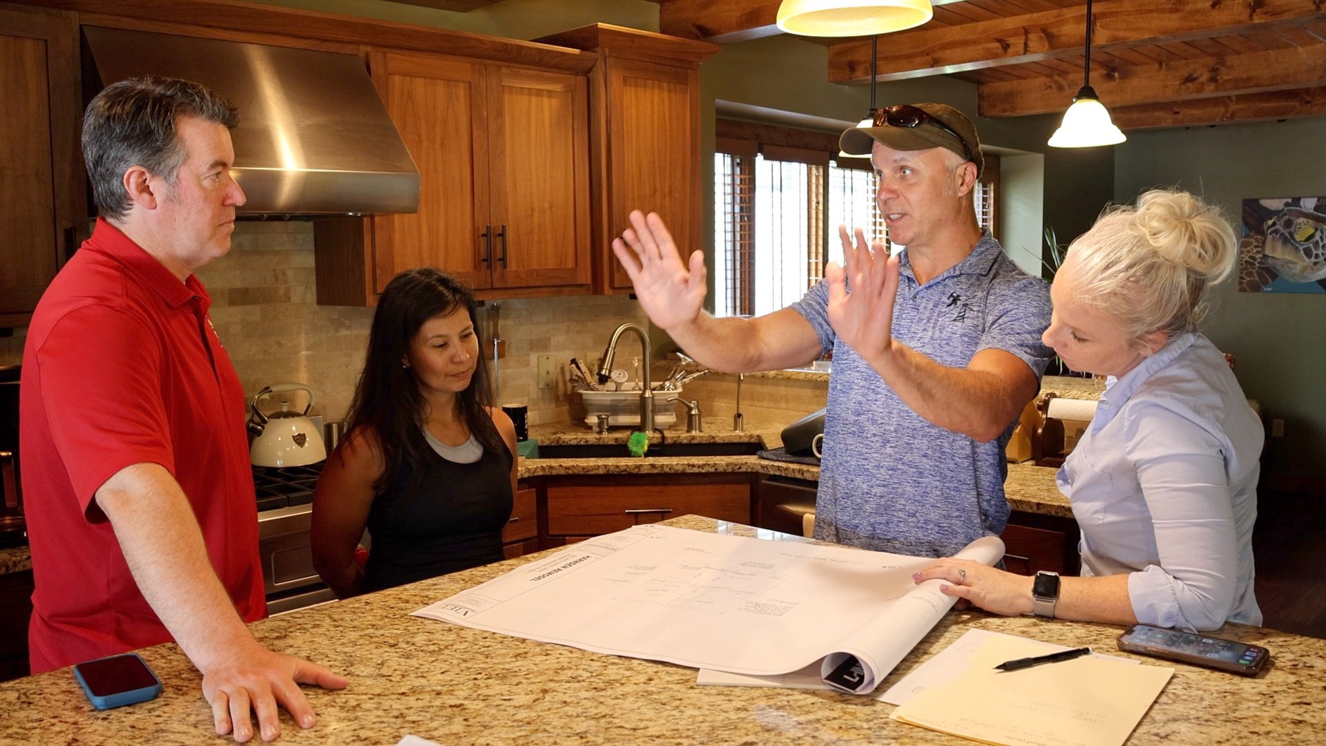 Ray, Ali, & clients discussing a kitchen remodel